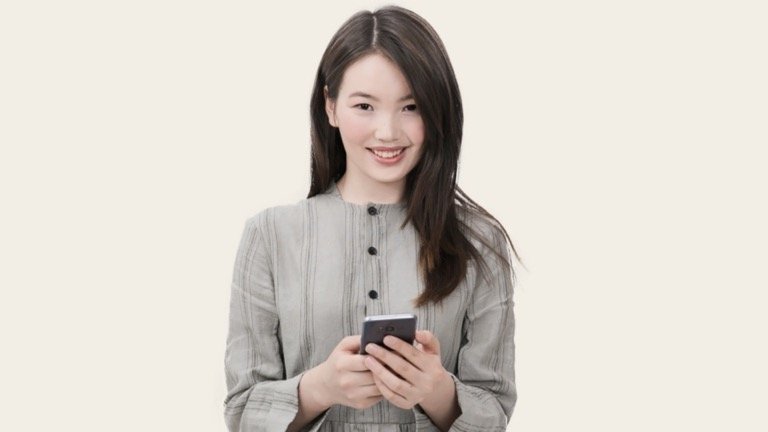 Smiling woman holding a smartphone, ready to sign in to an online store with one click